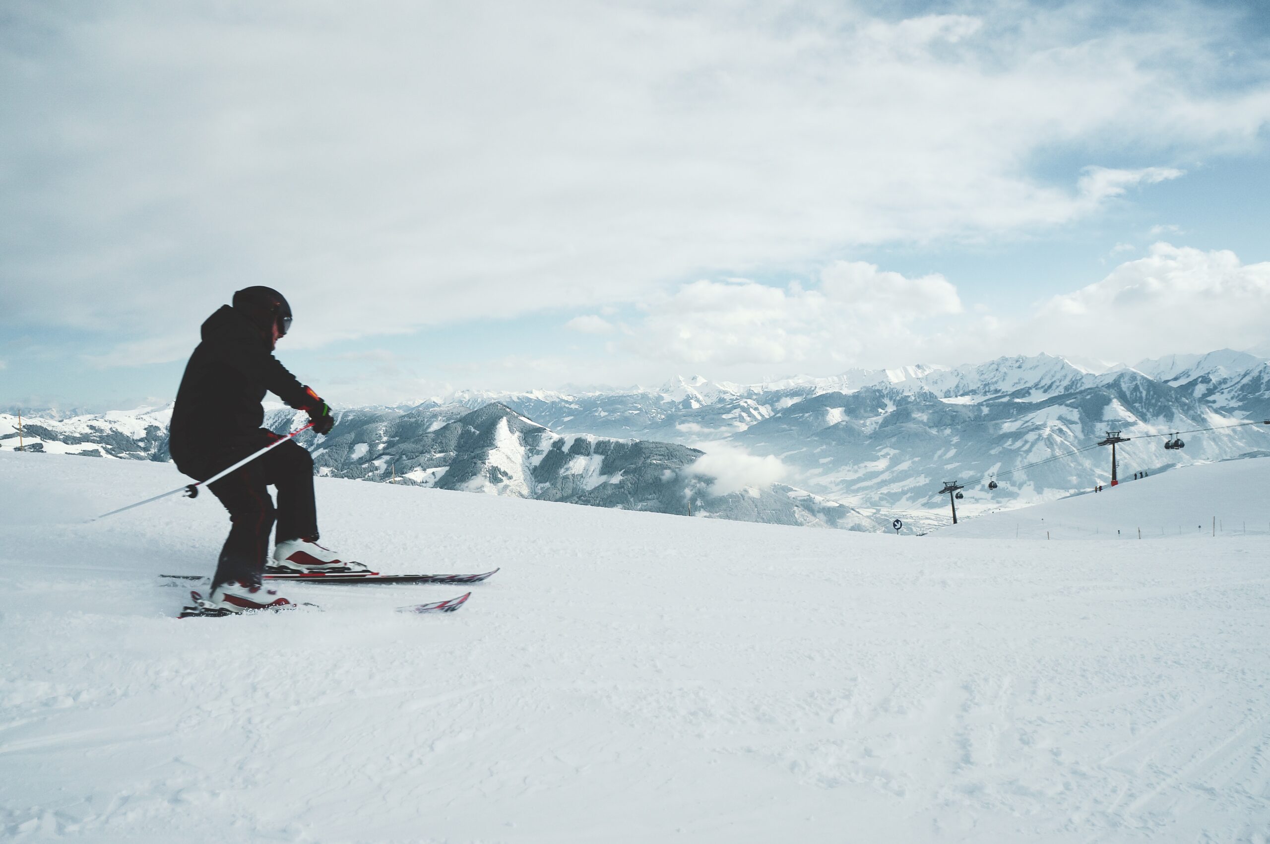 Beautiful shot of a man skiing on the mountains covered with white